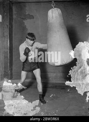 Daly puts punch into it . Training for match with Humsby . George Daly , the Blackfrisrs light weight is training at the Ring gymnasium Blackfriars , for his ten round match with Gustave Humery , the French Tiger and conqueror of Kid Berg . Daly , winner of the Control Board ' s series of light weight eliminators but ruled out ruled out because of his revolt against purse conditions , is hoping to prove that he is the rightful contender for Berg ' s British Championship . Photo shows , George Daly punching a bag during training at the Ring gymnasium . 10 January 1936 Stock Photo