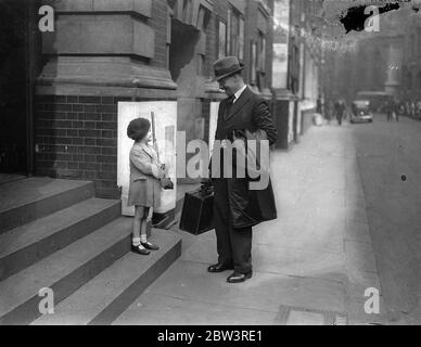 London 's  golden voiced  Sergeant Major returns to duty . To give postponed broadcast . Sergeant Major Patterson being welcomed back to the Recruiting Office by his four year old son Joe , on his return to duty . 19 March 1935 Stock Photo