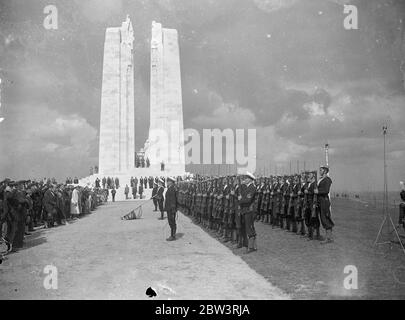The King Unveils Canada ' s Memorial To War Dead At Vimy Bridge . Ex - Servicemen Among Enormous Crowd . King Edward , in the presence of President Lebrun of France and six thousand Canadian war veterans , unveiled the impressive memorial to the 11,700 Canadians who fell on the battlefields over which the monument now towers at Vimy Ridge , near Arras , France . Thousands who had made special pilgrimage from Canada were among the enormous crowds gathered for the ceremony . Photo shows : The guard of honour of Canadian sailors at the salute during the unveiling . 26 Jul 1936 Stock Photo