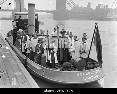 Beating bounds of St Dunstan ' s in East Church was carried out . A tug was used to take the party into the middle of the Thames at Tower Pier when the ceremony of Beating the Bounds of St Dunstan ' s in the East Church was carried out . Photo shows the ceremony aboard the tug . 25 May 1936 Stock Photo