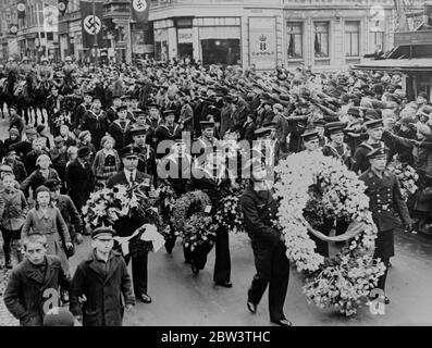 German Ambassador ' s body arrives at Wilhelmshaven . Procession through crowded streets . The body of Herr Leopold von Hoesch , the German Ambassador in London , who died on Good Friday following a heart attack arrived at Wilhelmshaven from England aboard the destroyer HMS Scout ( H 51 ) . Swastika flags hung at half mast through the town as the body was placed on a gun carriage and taken through the crowded streets to the station to be entrained from Dresden , where the funeral is to take place . King Edward is to be represented at the funeral in Dresden . Photo shows , British and German sa Stock Photo