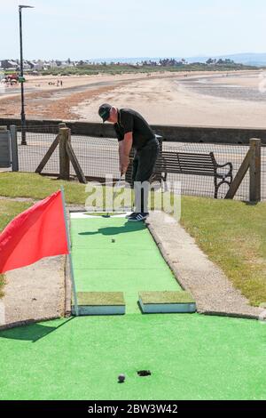 Troon, UK. 29th May, 2020. With the relaxation of lockdown measures and Nicola Sturgeon, the First Minister'of Scotland's indication that certain sporting facilities, including golf can be opened, Troon's famous Crazy Golf Course opened for the first time since October 2019. First to play on the course was Julie Barr and Willie Ramage, both from Troon. Credit: Findlay/Alamy Live News Stock Photo