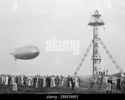 ' Hindenburg ' Germany ' s giant airship , at Rio De Janeiro . These pictures just received in London by air , show the ' Hindenburg ' , Germany ' s gigantic new airship , at the Santa Cruz aerodrome Rio de Janeiro agter her maiden voyage to South America from Friedrichshaven . A special mast and hangar had been built at the aerodrome to accommadate the new airship . Photo shows , the Hindenburg being steered towards the mouring mast at Rio de Janeiro . 13 April 1936 Stock Photo