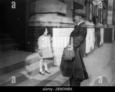 London 's  golden voiced  Sergeant Major returns to duty . To give postponed broadcast . Sergeant Major Patterson being welcomed back to the Recruiting Office by his four year old son Joe , on his return to duty . 19 March 1935 Stock Photo