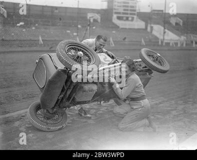 Woman driver takes up midget car racing . Fay Taylor , well known racing driver and once holder of the women ' s speedway championship , is now taking up midget car racing . She will compete all over the country Photo shows , Fay Taylor making an adjustment to her Sulman Special , midget car at West Ham Stadium , assisited by Tommy Sulman , the midget car designer and driver . 19 August 1936 Stock Photo