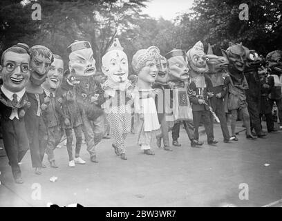 Grotesque heads in Southend carnival procession . A great six miles long carnival procession passed through the streets of Southend on the ' big day ' of Carnival week . Tens of thousands of people watched the gay cavalcade , which was led by the Carnival Queen . Photo shows , grotesque heads in the procession . 19 August 1936 Stock Photo
