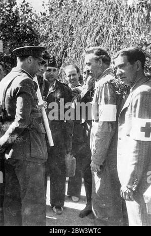 Loyalist General Arrives In Toledo To Direct Operations . General Ascensio , the Spanish Government commander in the south , travelled from his headquarters on the Talavera front to inspect operations at Toledo . It is reported that General Ascensio will take command in the town against the rebels who are still fighting despite the destruction of the Alcazar fortress . Photo shows : General Ascensio talking with Red Cross workers and soldiers during the civil war . 21 Sep 1936 Stock Photo