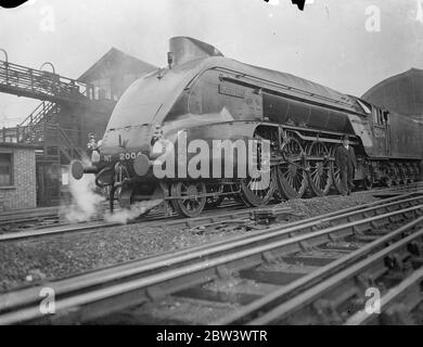 Britain ' s Most Powerful Engine , Streamlined Leaves London On First Run To Doncaster . Moons Meg , the latest type of streamlined locomotive and the most powerful passenger engine in Britain , left King ' s Cross Station on its first run to Doncaster . The locomotive weighs over 165 tons and was built specially for the East Coast services where there are steep gradients . Photo shows : Mons Meg leaving King ' s Cross for Doncaster pulling a train 550 tons in weight . 21 Aug 1936 Stock Photo