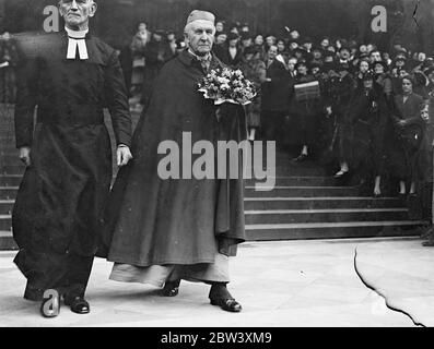 After distributing the first specially minted coins of the new reign in the Maundy Money ceremony at St Pauls Cathedral, the Archbishop of Canterbury, Lord High Almoner, left carrying his bouquet. He distributed the Royal Maundy to 42 men and 42 women corresponding to the years of the King's age. Photo shows: the Archbishop of Canterbury carrying his bouquet as he left St Paul's after the ceremony . March 25th 1937 Stock Photo