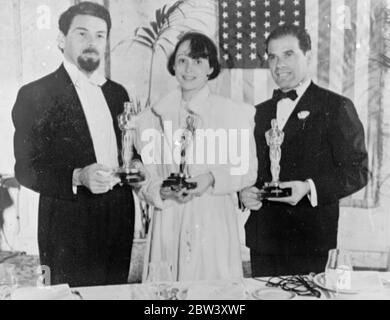 Hollywood ' s three best . Muni , Luise Rainer and Frank Capra . Paul Muni and Luise Rainer were chosen the best actor and actress of 1936 and Frank Capra the best director at the annual banquet of the Academy of Motion Picture Arts and Sciences in Los Angeles . Muni was selected for his work in the title role of ' The Story of Louis Pasteur ' , Miss Rainer for her role of Anna Held in ' The Great Ziegfeld ' and Capra for his direction of ' Mr Deeds Goes to Town ' . Photo shows , Paul Mui ( left ) , Luise Rainer and Frank Capra with their trophies . Muni has retained the beard he wore for a fi Stock Photo