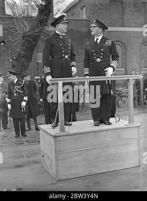 Admiral Evan inspects Navy training school commanded by man who rose from boy to Captain ' s rank . Admiral Sir E R Evans ( Evans of the Broke ) , Commander in Chief of the North , inspected the new boys training establishment . HMS Wildfire , which is under the command of Captain J Figgins . Captain Figgins is the first commander of the school , which is established in the building where he received his Navy Training as a boy . He joined the Navy in 1902 and was promoted from the lower deck to commision rank . Photo shows , Admiral Sir E R Evans and Captain J Figgins passing under the flag re Stock Photo