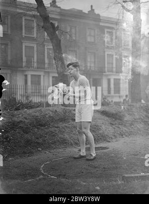 Son of German Ambassador competes against compatriots in London Athletic Contest. Rudolph von Ribbentrop, son of the German Ambassador, played for his school, Westminster School, against his country when an athletic contest took place at Vincent Square, Westminster, between the school and the party of German boys who are touring English schools and colleges. Photo shows: Rudolph von Ribbentrop wiping the weight as he competed in the putting the weight contest at the meeting. 6 March 1937 Stock Photo