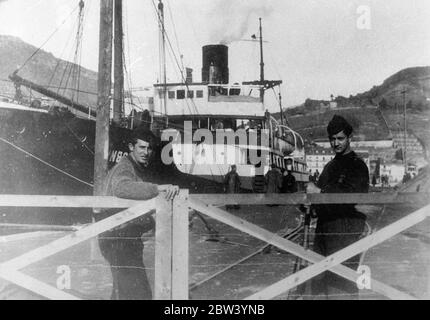 Soviet food ship captured by rebel warship held at nationalists port. Carrying £2000 of wheat, rye and lentils to Spain, another Soviet food ship, the 2485 t Smidovich has been seized by Spanish rebel warships in the Bay of Biscay off Santander and escorted to Pasajes, a Spanish Nationalist port. The Smidovich was bound from Leningrad with a cargo of foodstuffs sold to Spanish Republican trade organisations. Photo shows: the Soviet steamer Smidovich guarded by armed rebels in dock at Pasajes. 18 January 1937 Stock Photo