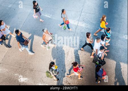 Shots of pedestrians crossing the road junction next to SM Clark Mall, Angeles City Mall, The Philippines. Stock Photo