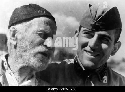 A man who was born just after the outbreak of the French Revolution and who has seen the world change through three centuries, has been discovered in the little village of Chalaubani, Georgia, Soviet Russia. Said to be the world's oldest man he is Andrei Gviniashvili, who has worked on the land most of his life. Born in the last decade of the 18th century, Andrei is 145 years old, but has the appearance of a man only half his age. Photo shows: Andrei Gviniashvili with a young Red Army soldier Ilo Kakhidze, home on furlough, at Chalaubani, Georgia USSR. 5 November 1936 Stock Photo