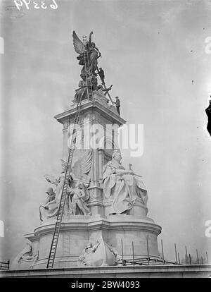 Victoria Memorial being cleaned for Coronation . The Victoria Memorial outside Buckingham Palace is being cleaned in preparation for the Coronation . Photo shows cleaning the Victoria Memorial . 12 April 1937 Stock Photo