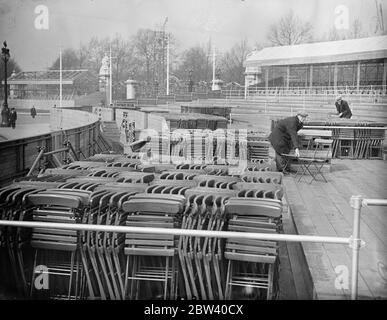 Stacking chairs for Coronation spectators . Thousands of chairs will be used to seat spectators on the Coronation stands around Buckingham Palace . Photo shows , arranging and stacking chairs near the palace as they arrived . 12 April 1937 Stock Photo