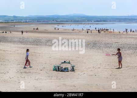 Troon, UK. 29th May, 2020. As the local temperatures rise to at least the mid 20's C, and with the relaxation of the covid 19 lockdown measures, people are once again returning to the beach. for pleasure while trying to maintain social distancing. Credit: Findlay/Alamy Live News Stock Photo