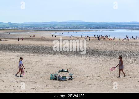 Troon, UK. 29th May, 2020. As the local temperatures rise to at least the mid 20's C, and with the relaxation of the covid 19 lockdown measures, people are once again returning to the beach. for pleasure while trying to maintain social distancing. Credit: Findlay/Alamy Live News Stock Photo