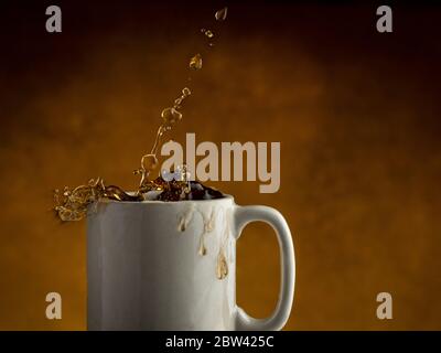 Coffee splashing out of coffee mug Stock Photo