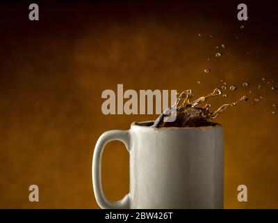 Coffee splashing out of coffee mug Stock Photo