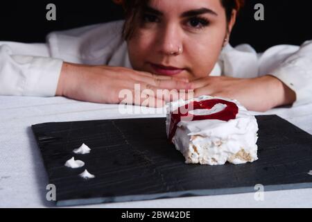 student preparing pastry in the black background Stock Photo