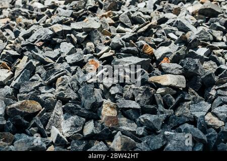 Rough stones, crushed stone, granite gravel close-up. The rough texture of the stone. Building material background. Texture Stock Photo