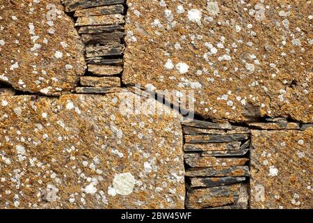 Detail of hand laid rock wall, dry wall construction technique. Stock Photo