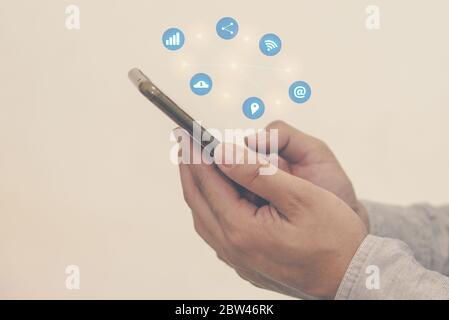 Man with a hand holding a smartphone on social media.Digital network  concept. Stock Photo