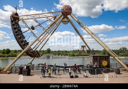 Leipzig, Germany. 29th May, 2020. Visitors take a ride on a giant swing boat in the Belantis amusement park. Saxony's Minister of Tourism praised the leisure and amusement parks in the Free State for their commitment and sense of responsibility in implementing the hygiene requirements. Since 15 May, amusement parks in Saxony have also been allowed to reopen. The industry is faced with the challenge of meeting the special corona hygiene requirements and ensuring the protection of guests and employees. Credit: Jan Woitas/dpa-Zentralbild/dpa/Alamy Live News Stock Photo