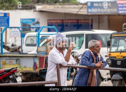 Somnath, Gujarat, India - December 2018: A candid portrait of an Indian man with a mustache and a stubble standing beside another man. Stock Photo