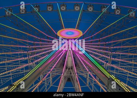 Giant ferris wheel illuminated at night, view up, Winter Wonderland Hyde Park, London, UK Stock Photo