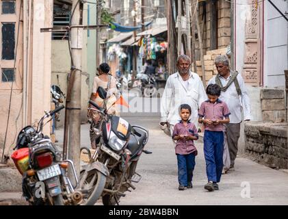Somnath, Gujarat, India - December 2018: Elderly Indian men walking in an alley in the old town. Stock Photo