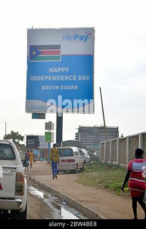 Oversized advertising poster of a mobile phone financial service provider with a temporal reference to the South Sudanese national day on one of the main streets in the South Sudanese capital of Juba, taken on 14.12.2019. Through the services of such service providers, financial transactions should also be made possible for those parts of the population who otherwise have no direct access to a financial institution. Photo: Matthias Todt/dpa-Zentralbild/ZB/Picture Alliance | usage worldwide Stock Photo