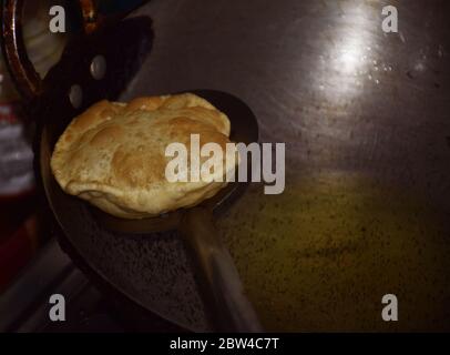 Bengali Food - Preparation of Bengali traditional dish or cuisine  Luchi or Indian Poori. Indian Dish, Indian Food, Indian cuisine Stock Photo