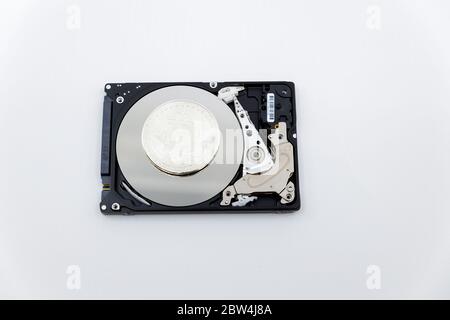 Silver bitcoin token on top of an open hard drive.Worldwide virtual internet cryptocurrency and digital payment system.Digital coin money crypto curre Stock Photo
