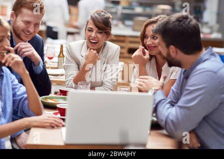 Business casual coworkers having lunch break in the office restaurant Stock Photo