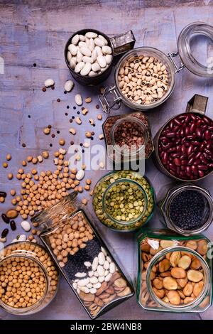 large variety of dried legumes in glass jars. background texture with top view Stock Photo