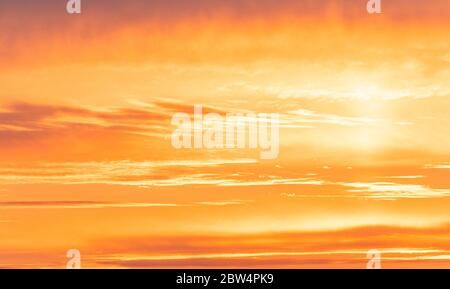 Amazing sky during golden sunset, bright orange sky with sunlight Stock Photo