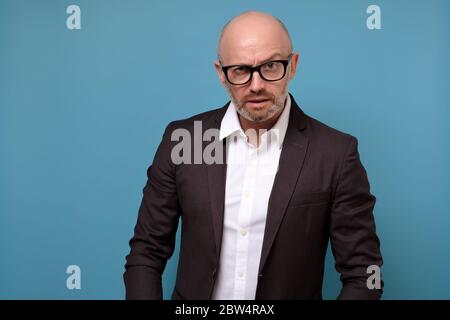 mature man looking with mistrust does not believe in news or government. Stock Photo