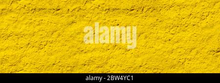 Abstract background of yellow dry powder paint.Yellow texture