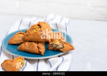 Tatar pie triangle echpochmak, Russian kurnik, delicious pastry with  chicken and potatoes. Traditional food, quick snack of dough Stock Photo -  Alamy