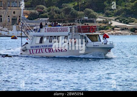 VALLETTA, MALTA - NOVEMBER 10TH 2019: Harbour cruise vessel arrives back in Sliema after a round the island trip. Stock Photo