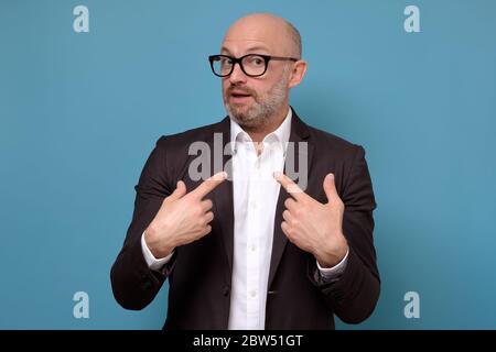 man looking disappointedly at camera pointing at himself with hands Stock Photo