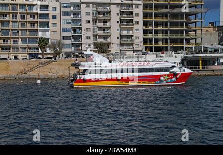 VALLETTA, MALTA - NOVEMBER 10TH 2019: Harbour cruise glass bottom boat about to set sail from Sliema dock Stock Photo
