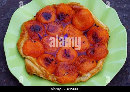 Homemade upside-down Tarte Tatin with apricots and lavender Stock Photo