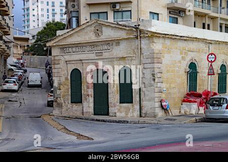 SLIEMA, MALTA - NOVEMBER 2ND 2019: The sea water distilling plant stands on the sea front. It was built in 1881 to supply drinking water to the island Stock Photo