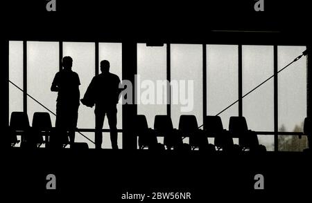 Freiburg Im Breisgau, Germany. 29th May, 2020. Football: Bundesliga, SC Freiburg - Bayer Leverkusen, 29th matchday at the Black Forest Stadium. Silhouettes of two people in the stands. Credit: Ronald Wittek/epa/Pool/dpa - IMPORTANT NOTE: In accordance with the regulations of the DFL Deutsche Fußball Liga and the DFB Deutscher Fußball-Bund, it is prohibited to exploit or have exploited in the stadium and/or from the game taken photographs in the form of sequence images and/or video-like photo series./dpa/Alamy Live News Stock Photo