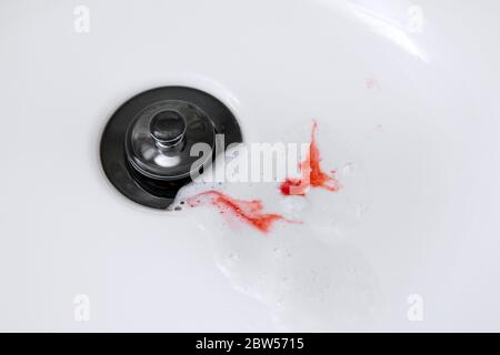 bleeding gums when brushing teeth. toothpaste with blood in the sink Stock Photo