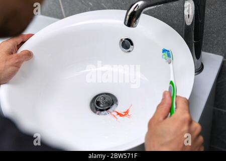 man have bleeding gums while brushing the teeth. tooth decay and gingvitis concept Stock Photo